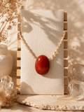 Pear-shaped carnelian pendant. Handcrafted with macramé.